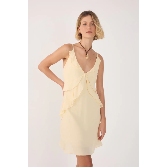 Woman wearing a light yellow dress with a white background