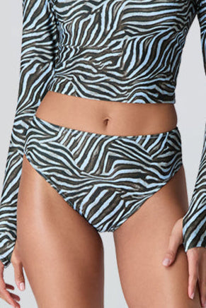 Female model wearing Watskin Clara rashguard and Belle bikini bottom in Blue Zebra