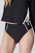 Woman wearing Watskin Sasha Tee and Belle bikini bottom in black with white tipping