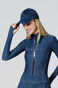Woman modeling Watskin Billie baseball cap with skirt and bodysuit in Blue Denim