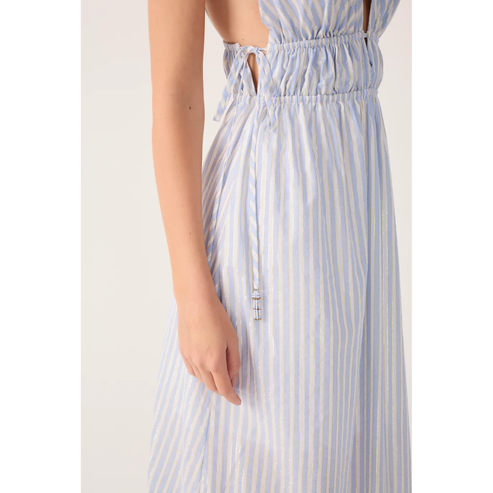 Close-up of a person wearing a blue and white striped dress on a plain background