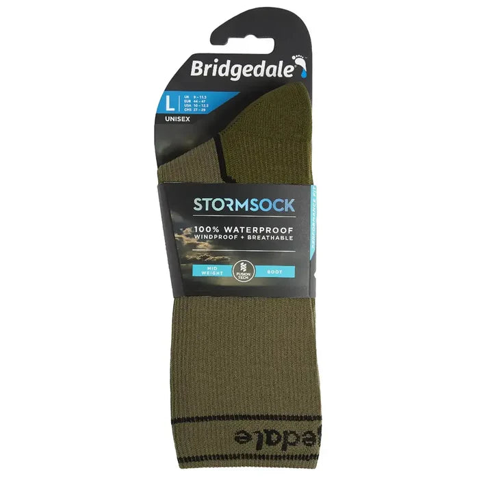 Retail packaging of Bridgedale Storm Waterproof Socks Midweight in green/black, featuring size L unisex label and waterproof performance tag.  from  John Bull Clothing