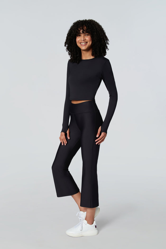 Female model wearing Watskin Clara top and cropped flare pants in Black