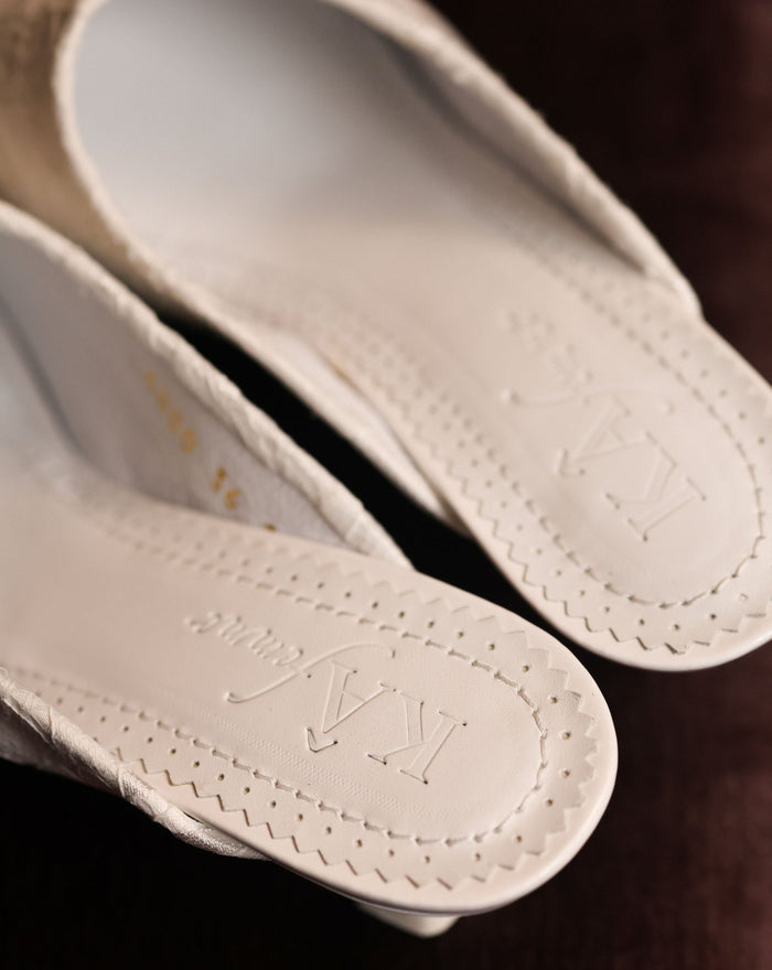 Close-up of the genuine leather insole featuring the brand logo, emphasizing the refined quality of the Slippers.