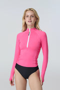 Front view of a woman wearing a bright lime green long-sleeve 1/2 zip rashguard with side ruching