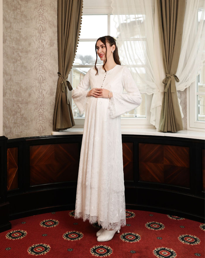 A dynamic side view of the Modest Lounge Dress, highlighting the flattering maternity fit and soft lace movement.