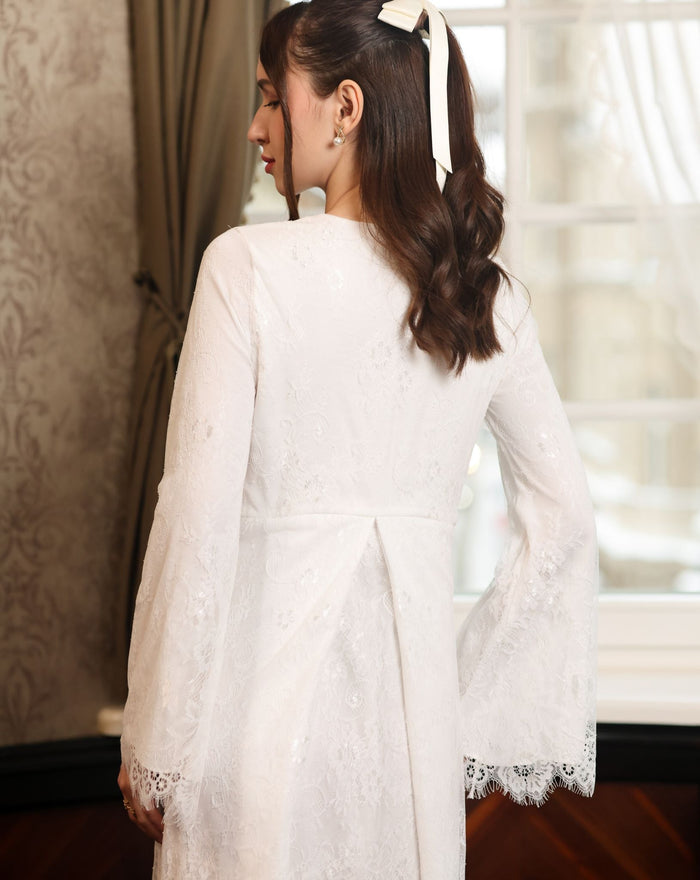 Back perspective of the floor-length lace gown, illustrating the heirloom quality and full coverage of the design.
