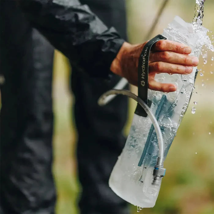 HydraPak Contour Clear Water Reservoir in use outdoors, demonstrating flexible and leak-proof hydration system for hikers and campers.  from  John Bull Clothing
