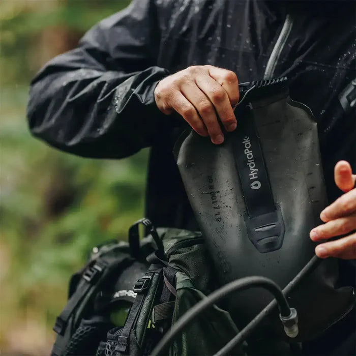 HydraPak Force Tactical Grey Water Reservoir being filled in a forest setting, ideal for tactical and mountaineering use | John Bulls  from  John Bull Clothing