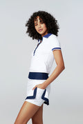 Left side view of female modeling Watskin Emma tee and Jojo tennis skirt