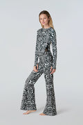 Blonde woman with right leg popped modeling Watskin Sasha teeand Juliet pant in Black Ikat