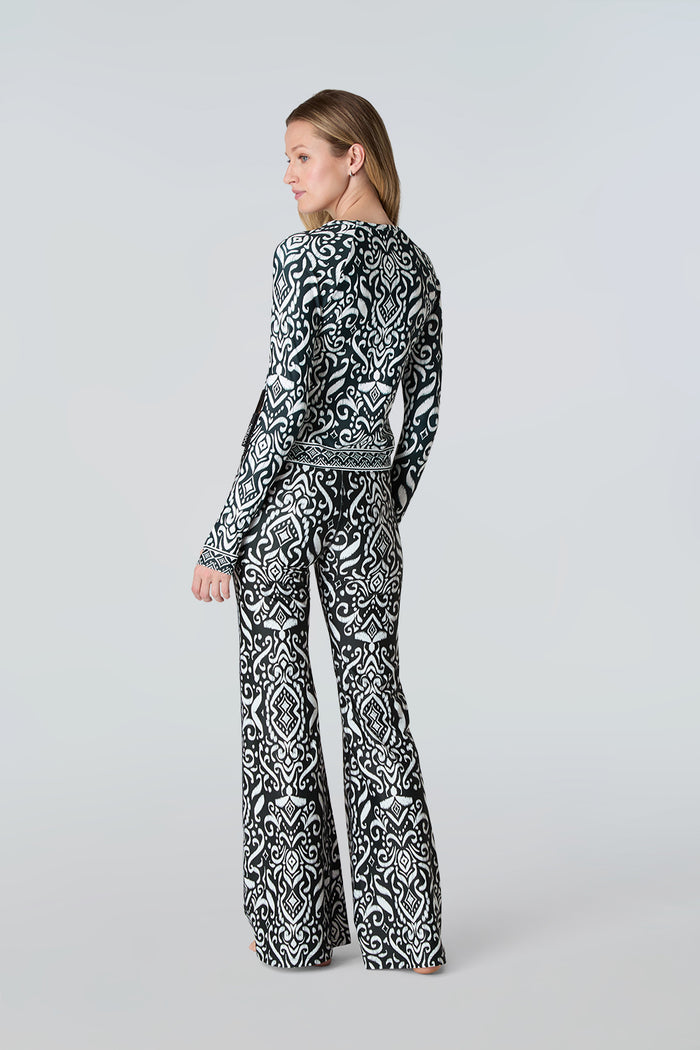 Woman modeling Watskin top and Juliet pant both in Black Ikat against a light gray background