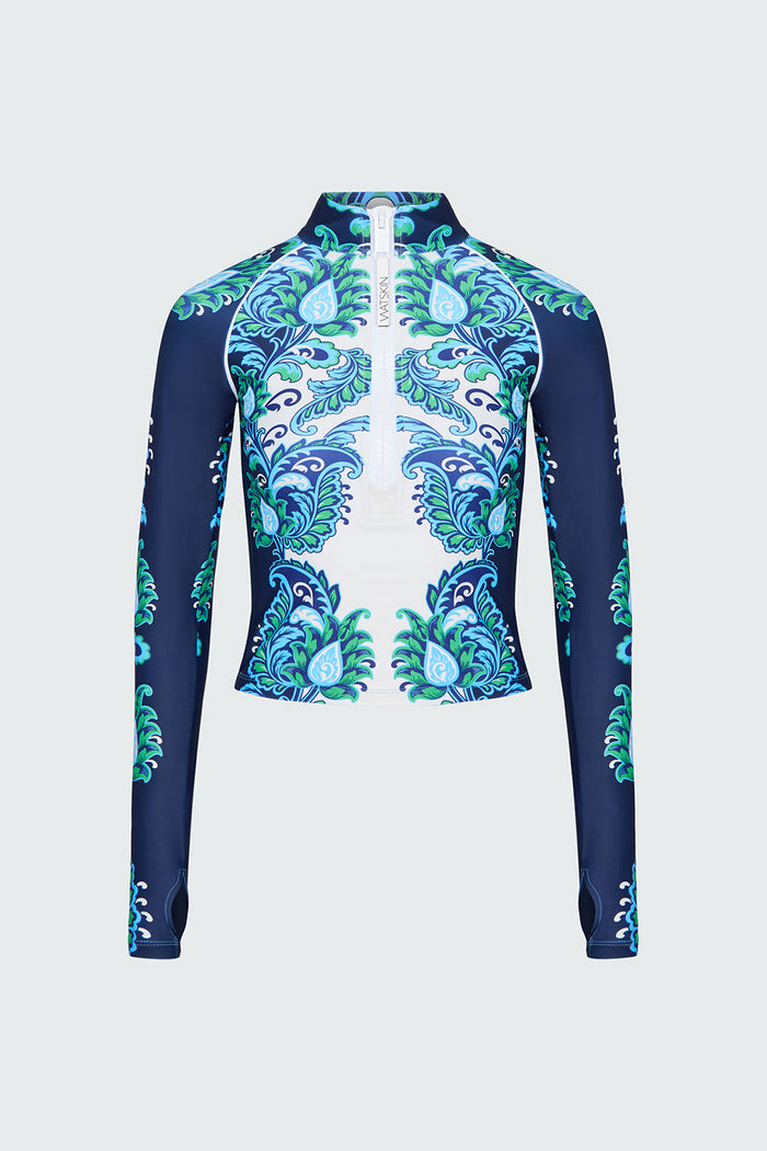 Navy, green and white floral patterned long-sleeve top on a light gray background