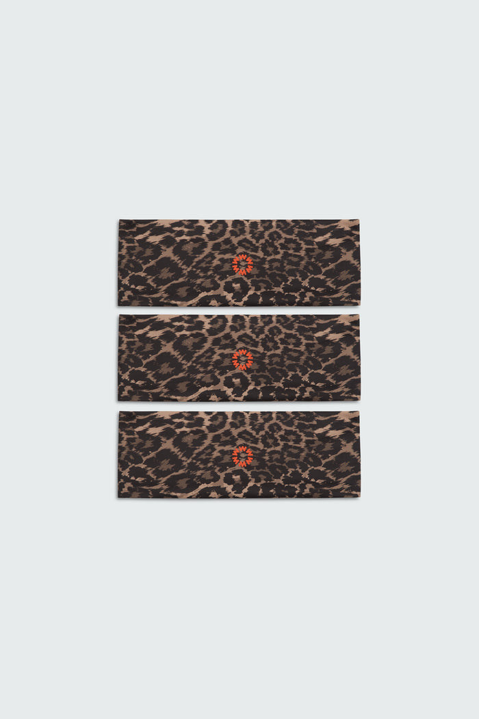 Close up photo of a set of three Watskin Lilly headbands in Leopard against a white background. Each features a small red sun logo in the center.
