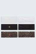 Close up photo of six Watskin Lilly headbands in Multi, each featuring a different look. Top two are white, middle two are black and bottom two are brown leopard print. One each of the black and white features a bow detail.