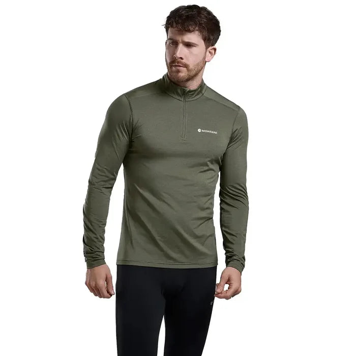 Model wearing Montane Mens Dart XT Zip Neck Long Sleeved Thermal Top in olive green, showcasing fit and performance-ready design.  from  John Bull Clothing