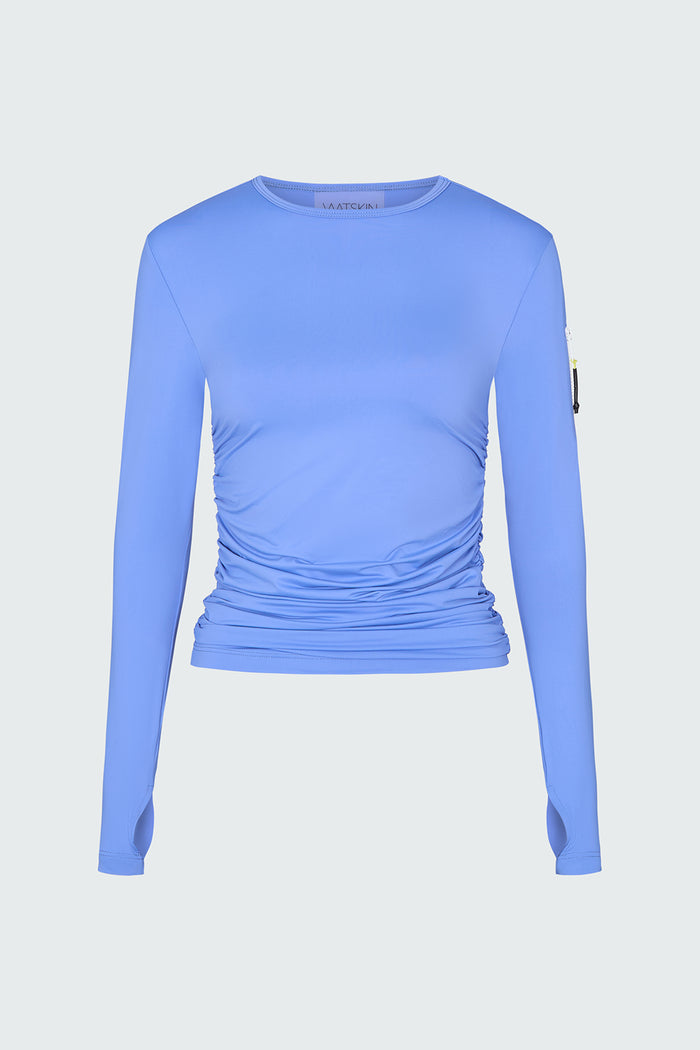 A light blue long-sleeve sun protective tee with side ruching and arm zip