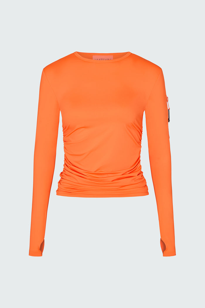 Orange long-sleeve sun protective tee with side ruching and arm zip pocket