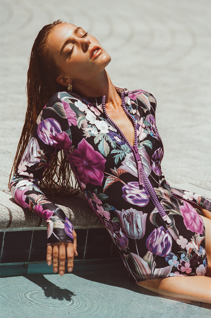 Female model wearing Ryann long sleeved thumbhole bodysuit in Orchid Bloom