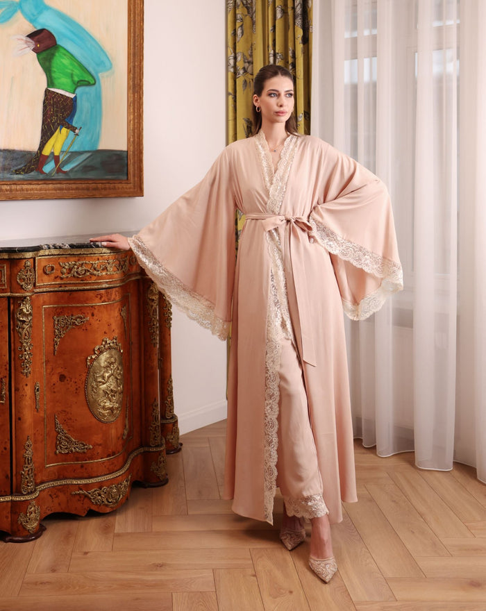A poised shot focusing on the wide, flared sleeves of the robe, highlighted by refined lace for a touch of grace.