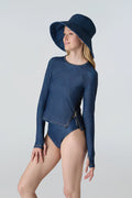 Woman wearing Watskin Sienna sunhat, Sasha tee and Belle mid rise bikini bottom in Blue Denim