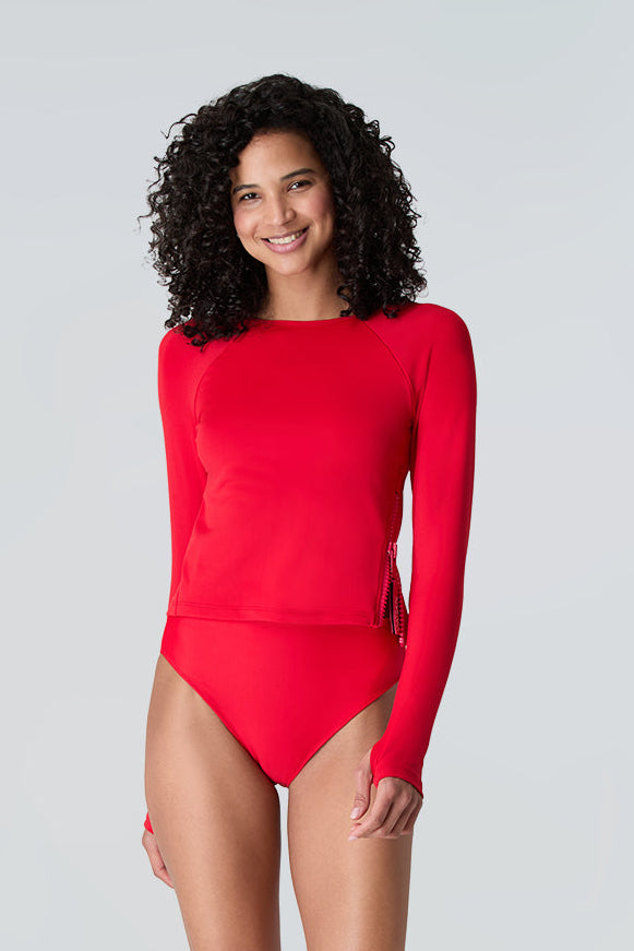 Female wearing Watskin Sasha tee and Belle mid rise bikini bottom in Red standing against a light background