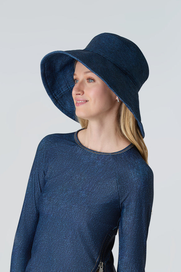 Woman wearing Watskin Sienna sun hat and rashguard in Blue Denim