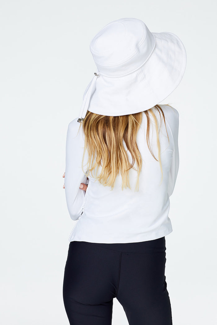 Rear view of woman wearing Watskin Sienna Hat and Sasha Tee in White with black pants