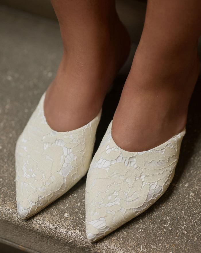 Top view of the Satin Slippers on feet, highlighting the delicate French lace and refined edge.