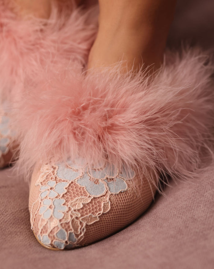 Close-up shot focusing on the meticulous balance of feathers and the smooth, high-quality materials of the slipper.